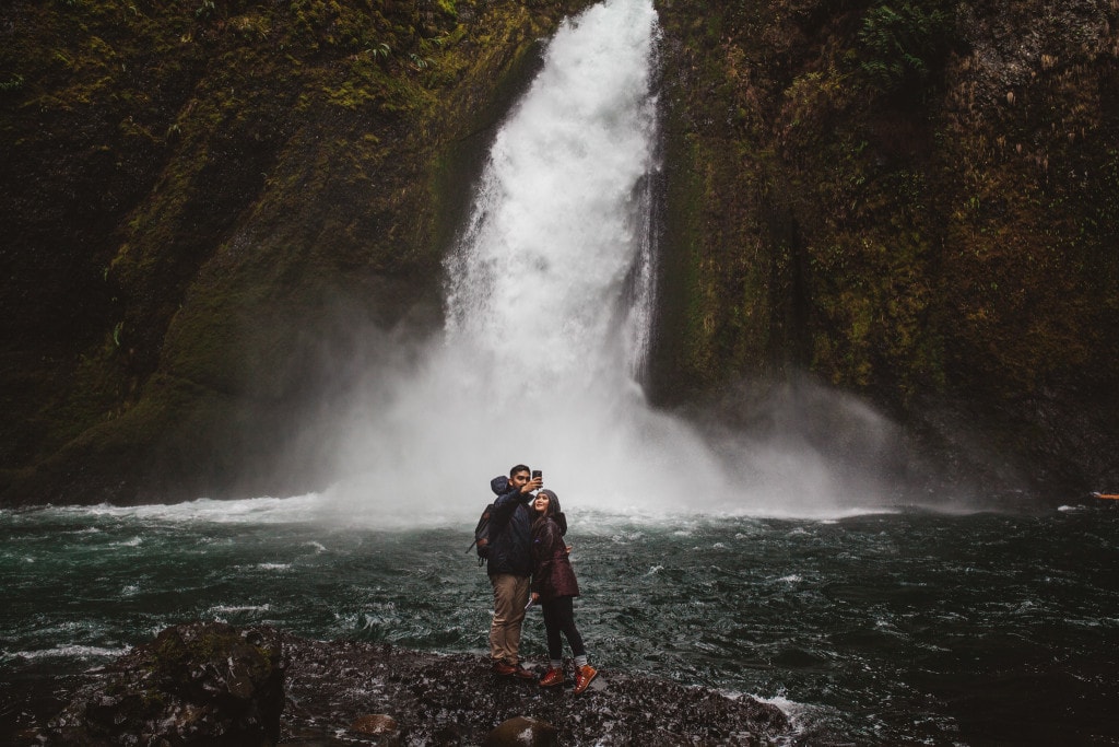 cute couple selfie Wahclella Falls by Marcela Pulido Portland Wedding Photographer