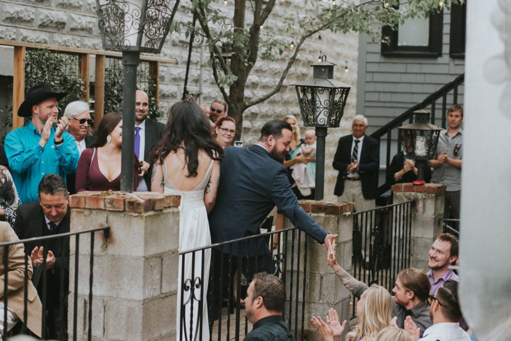 groom high five down aisle Portland Opal 28 Wedding Photographer Marcela Pulido