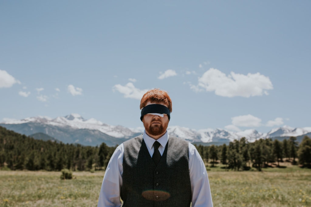 blindfolded groom first look rocky mountain national park