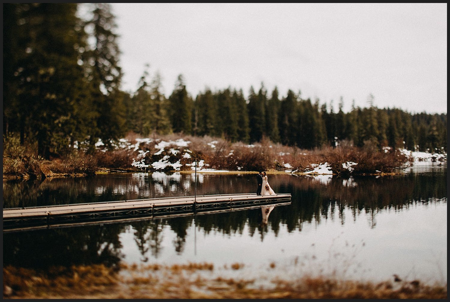 beautiful couple reflection in lake for their wedding Mckenzie river wedding at Clear lake