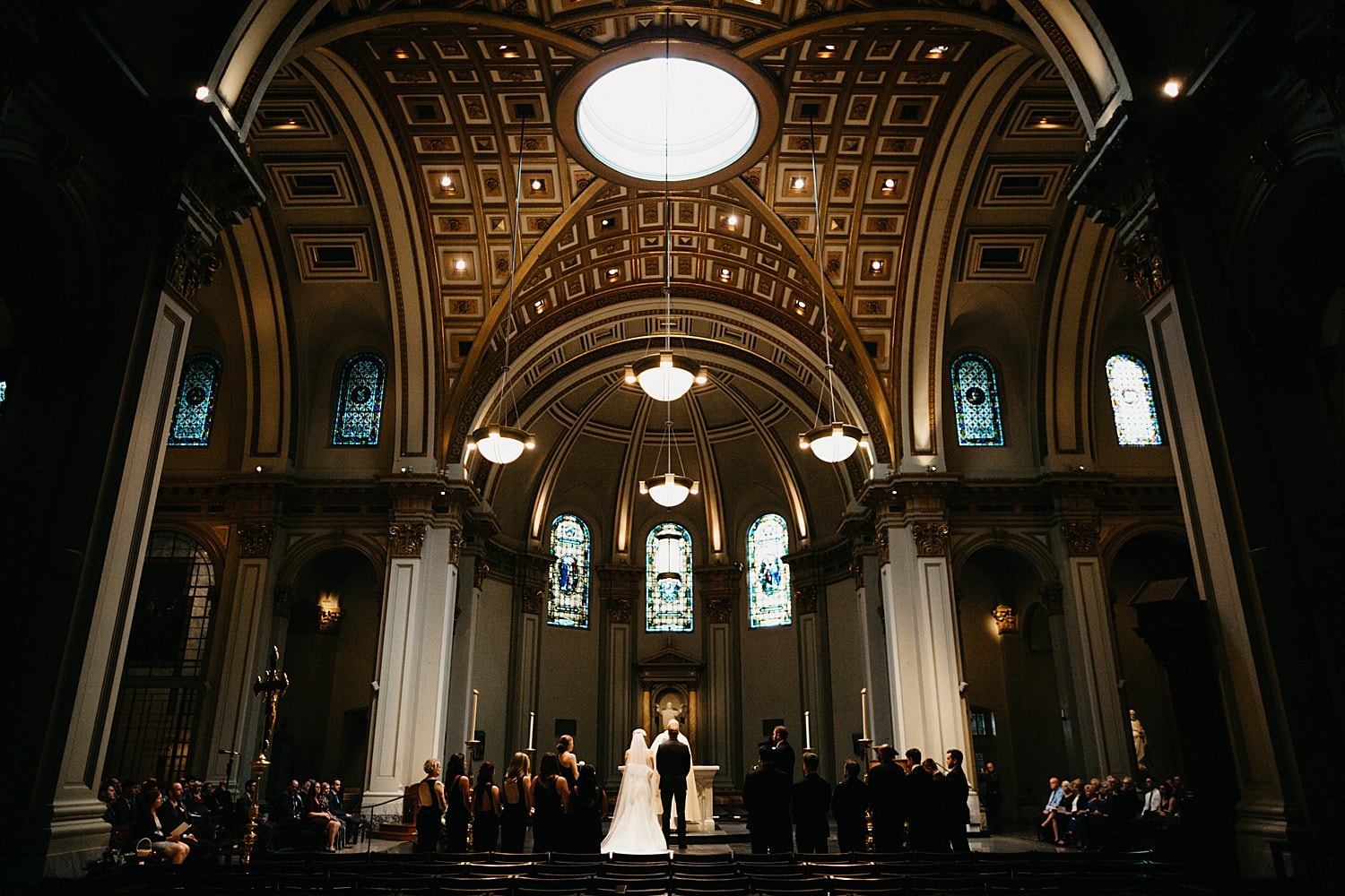 stunning shot of the bride and groom on the altar at st james cathedral during their catholic wedding ceremony 415 Westlake Wedding by Marcela Pulido Seattle Wedding Photographer