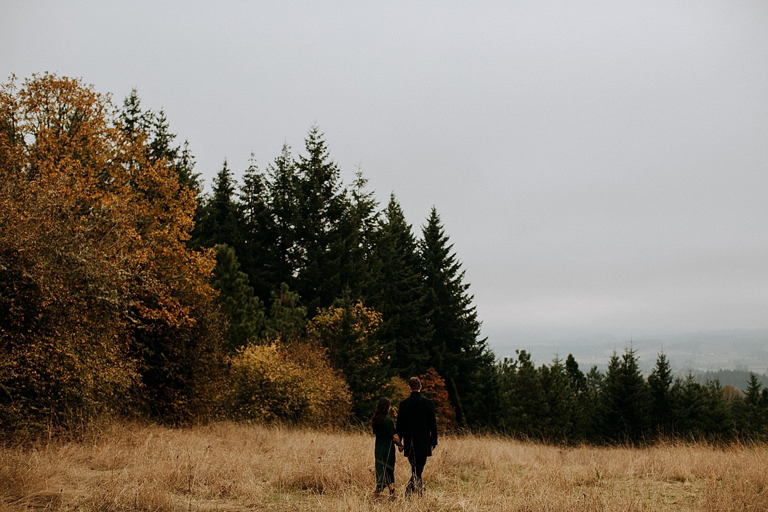 cute couple taking in the view from Cooper Mountain Engagement session by Portland engagement photographer Marcela Pulido