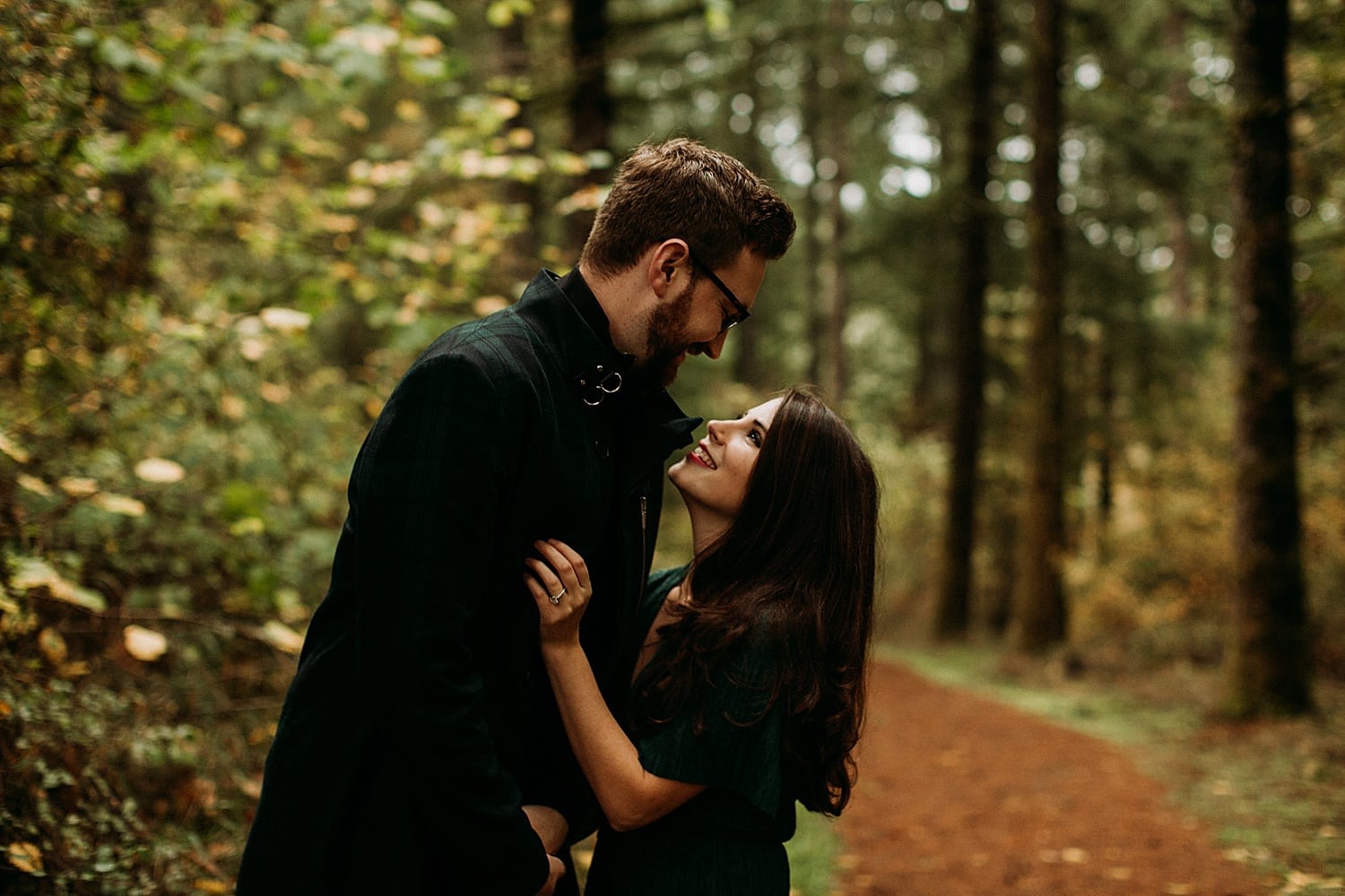 couple staring adoringly at each other in the forest Cooper Mountain Engagement session by Portland engagement photographer Marcela Pulido