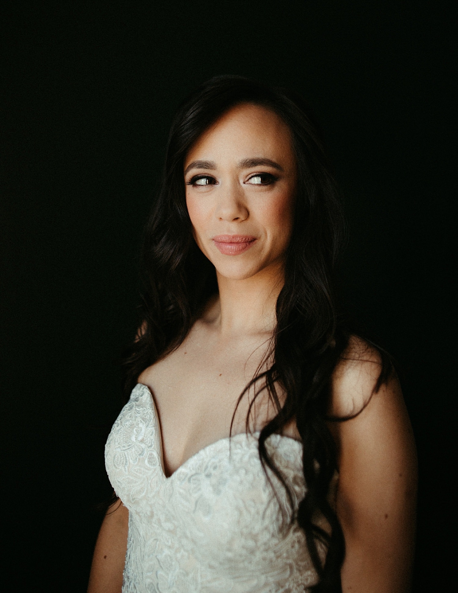 portrait of a bride against a dark wall at the sentinel hotel by marcela pulido photography portland wedding photographer