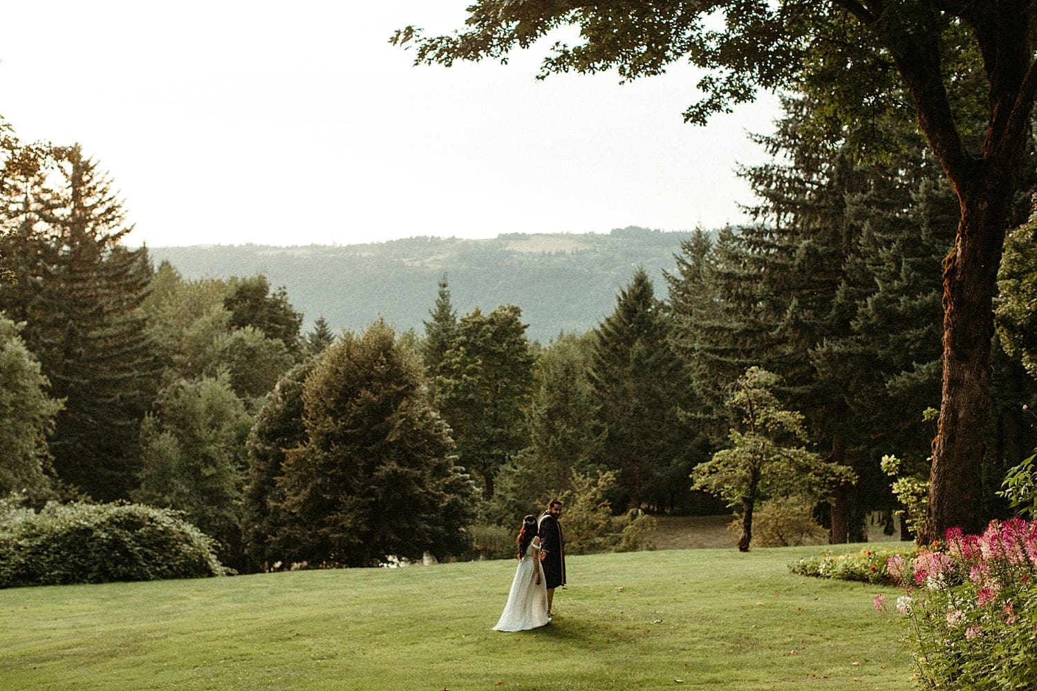 bride and groom walking into the sunset at bridal veil lakes by marcela pulido photography portland wedding photographer