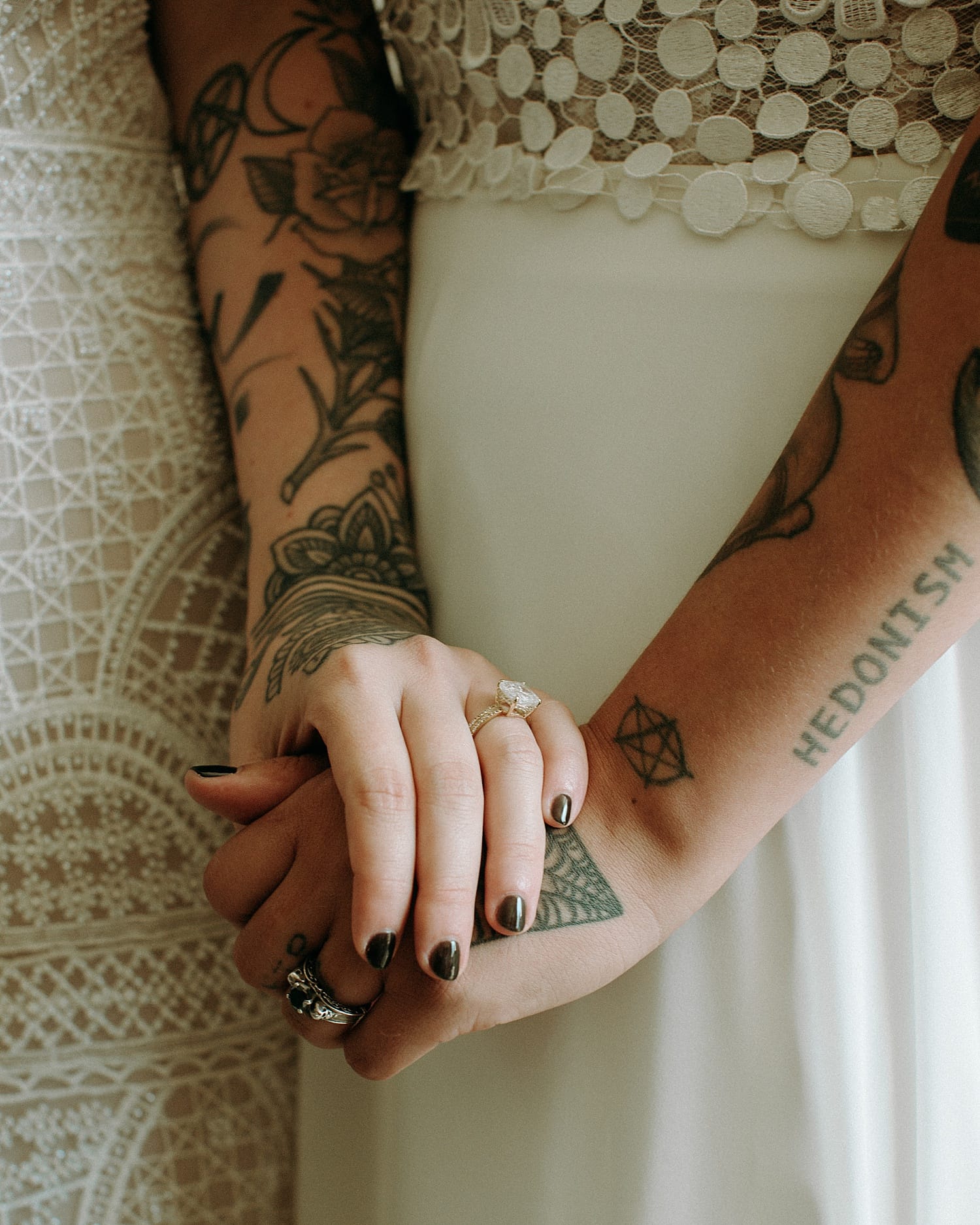 close up shot of lesbian tattooed brides holding hands by marcela pulido photography portland wedding photographer