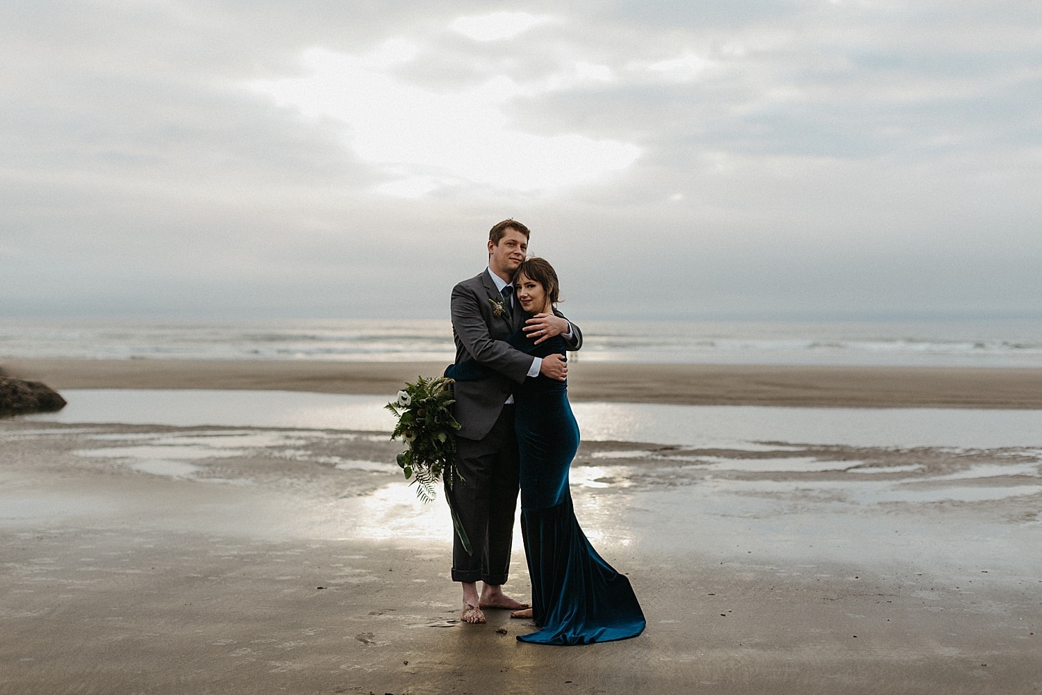 couple embracing on the foggy oregon coast hug point elopement captured by marcela pulido photography portland oregon wedding elopement photographer