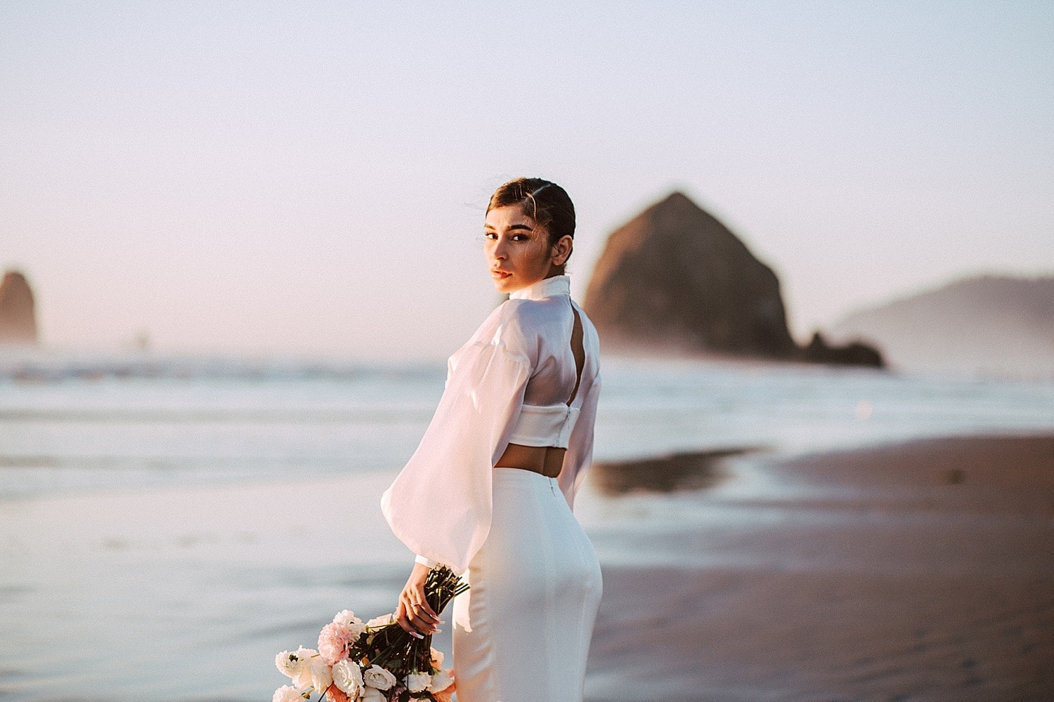 stunning portrait of gorgeous latina bride at cannon beach captured by marcela pulido portland oregon wedding photographer