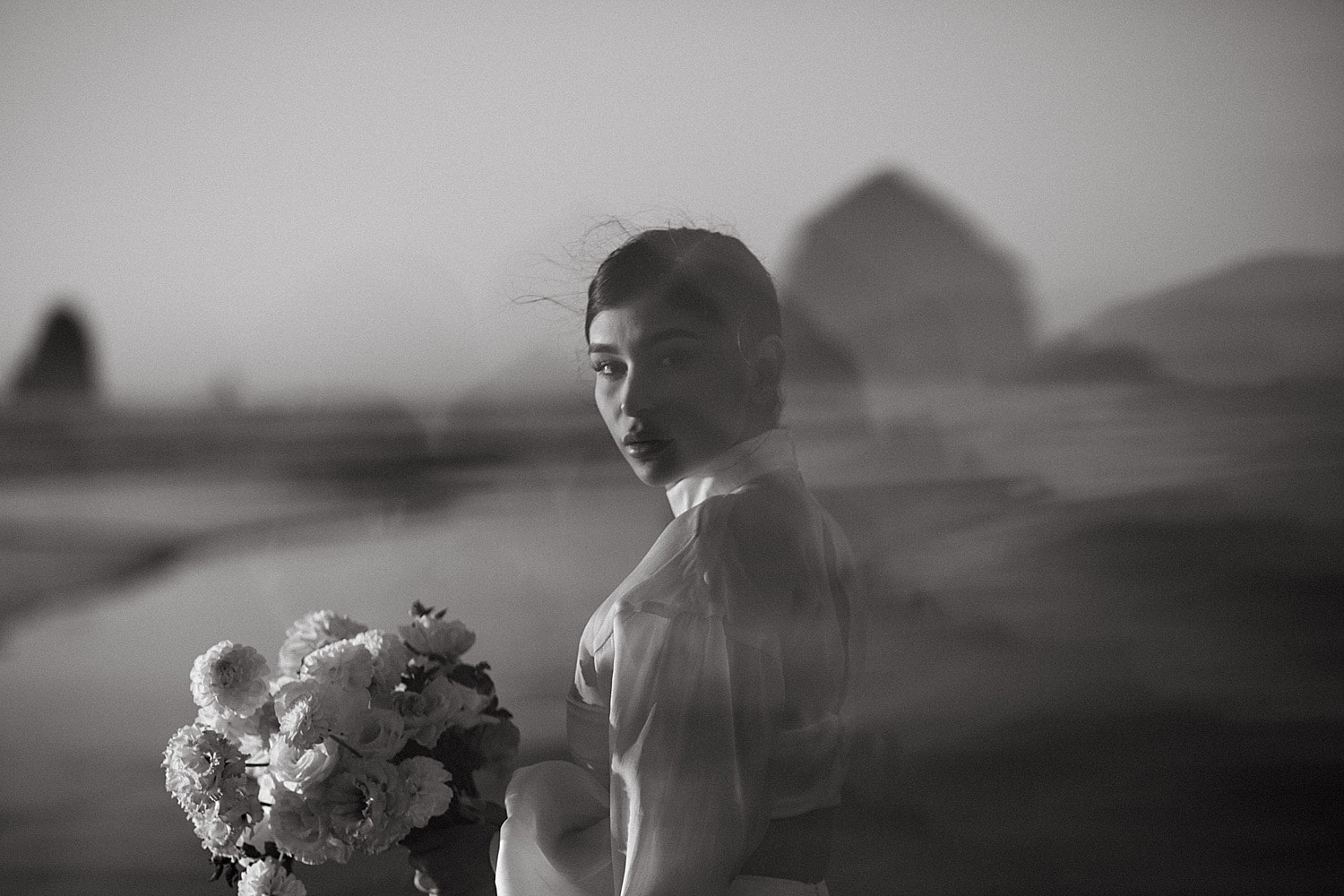black and white portrait of a gorgeous latina bride at her cannon beach elopement captured by marcela pulido portland oregon wedding photographer