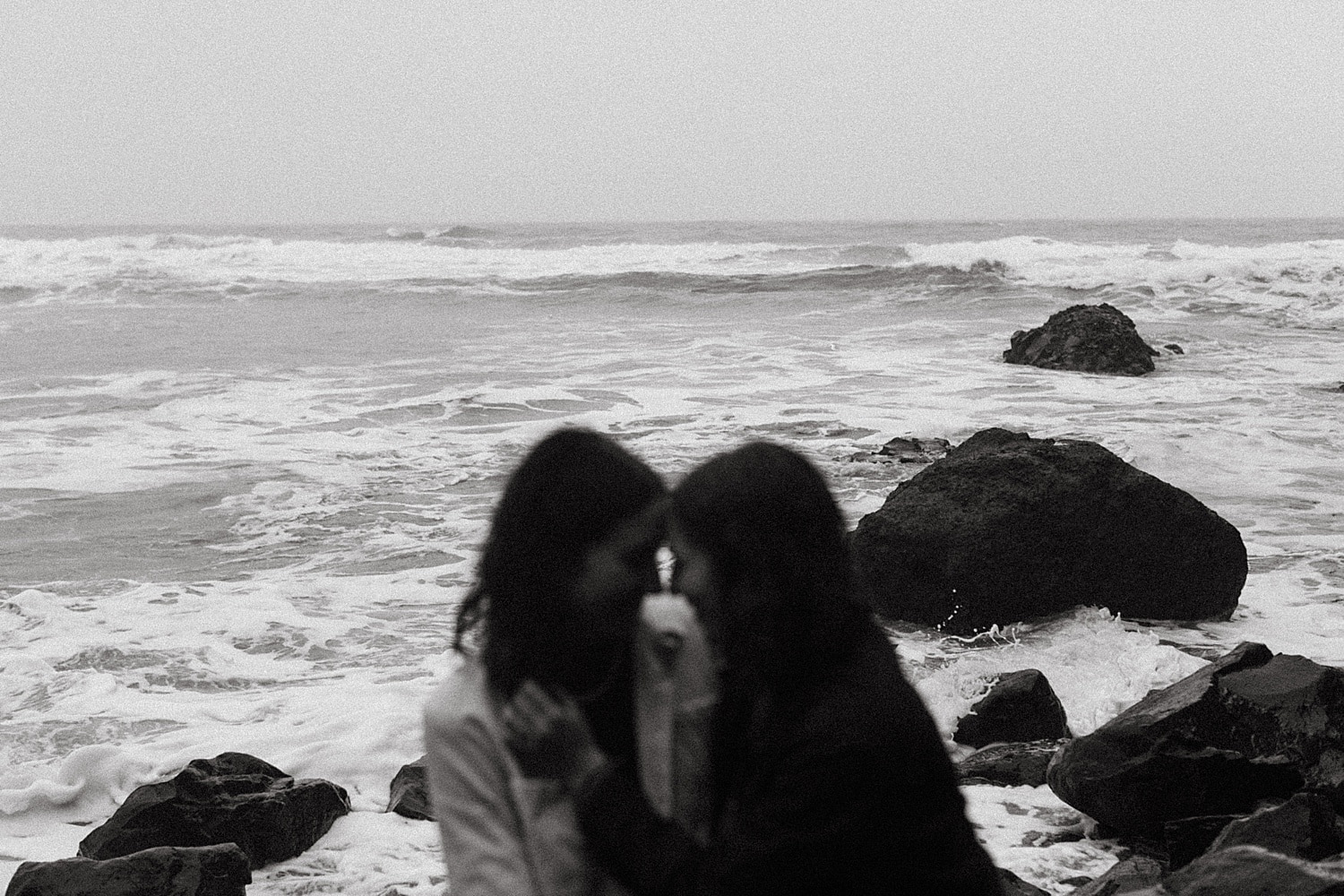 black and white cinematic portrait of a same sex lesbian couple on the beach by Marcela Pulido Portland Wedding Photographer