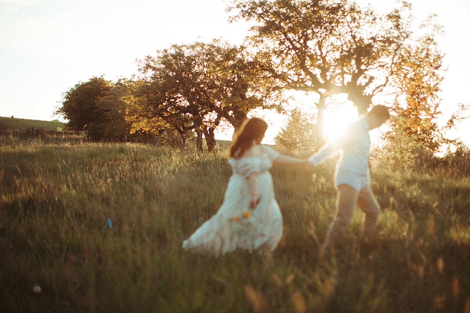 adorable asian couple walking in a field during golden hour at powell butte park in portland oregon cottagecore engagement session
