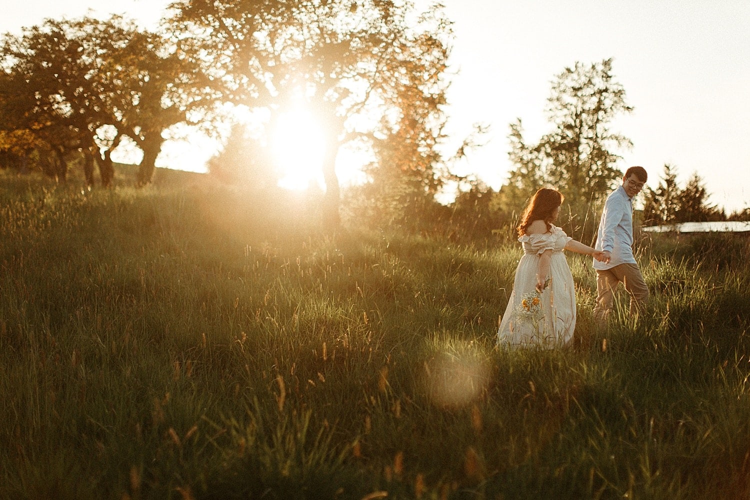 adorable asian couple walking in a field during golden hour at powell butte park in portland oregon cottagecore engagement session