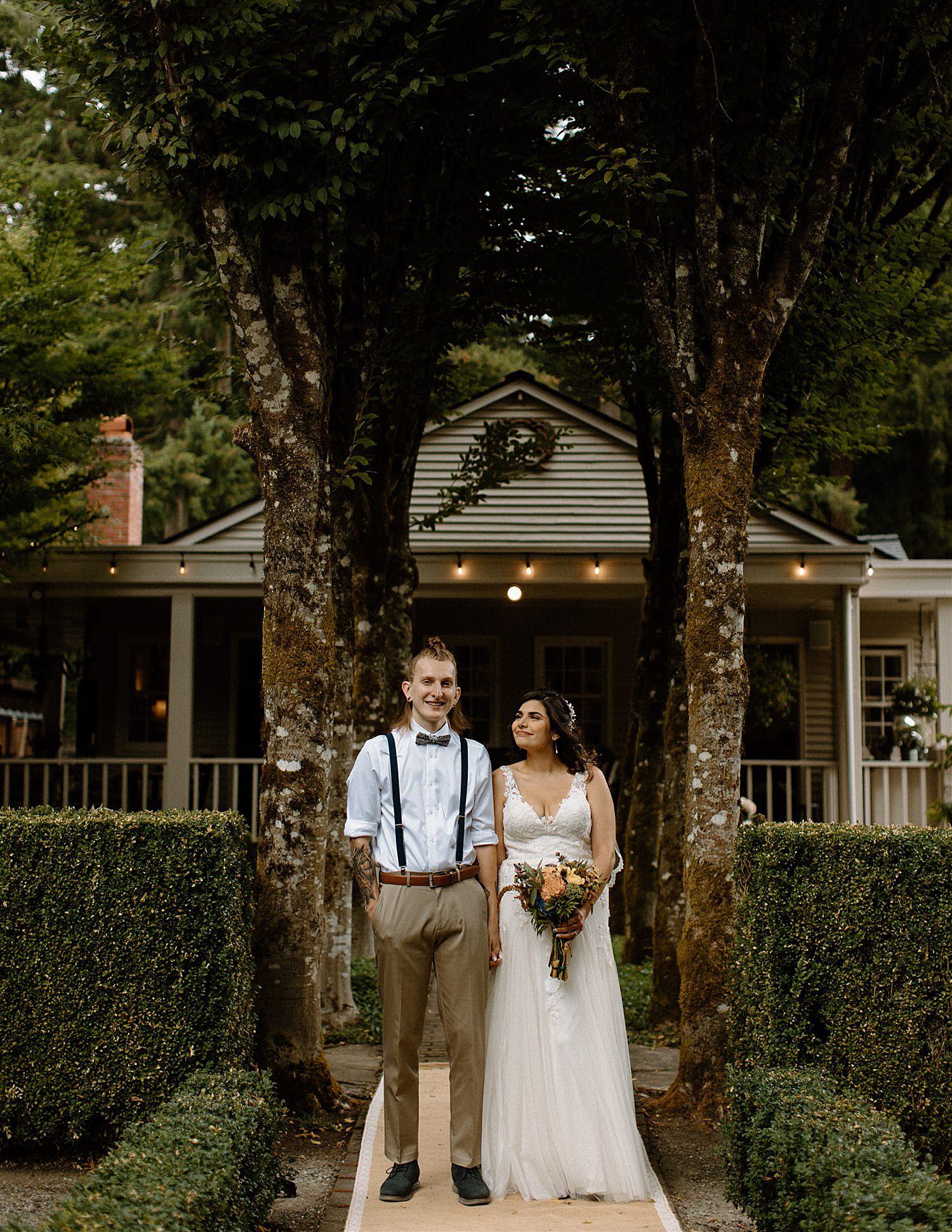 bride and groom stare adoringly at each other at this brick fence at their french country cottage wedding in lakewood washington