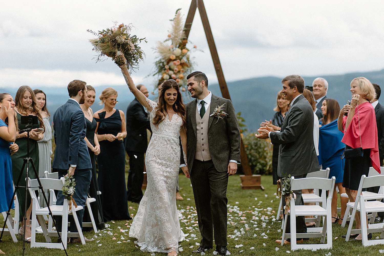 newlywed couple celebrating exchanging their vows after their ceremony at gorge crest vineyards as captured by Portland Wedding Photographer Marcela Pulido